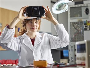 Engineer with white lab coat with VR goggles