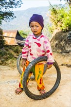 Little boy with tires as toys