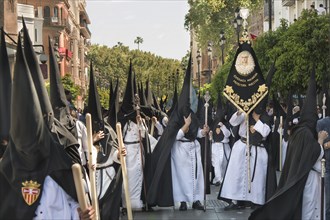 Penitents with picture of the Virgin Mary during the procession at Easter