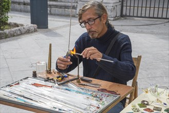 Man creating glass jewelry