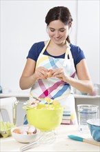 Young woman baking cake