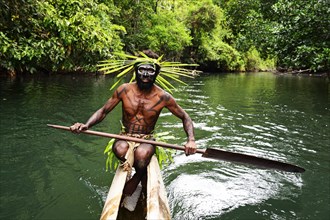 Korafe-Man paddling in a dugout boat