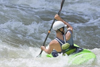 Kayak surfing in whitewater