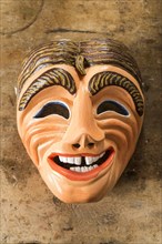 Painted wooden mask on a workbench