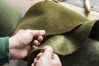 Hands checking different wool felt hat bodies