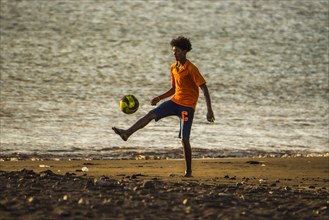 Teenager playing soccer