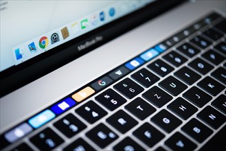 Backlit keyboard and Touch Bar showing websites