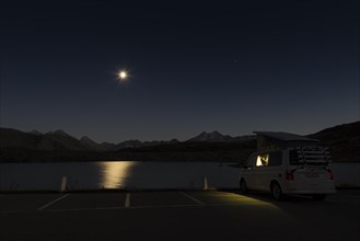 Motorhomes on a starry night in the Swiss Alps