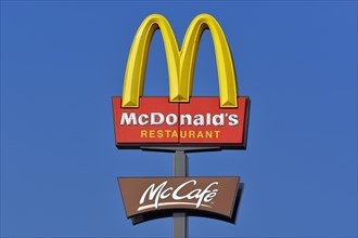 McDonalds sign against a blue sky