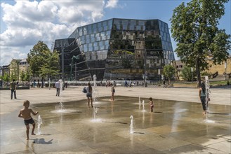 Playing children at the fountain in front of the university library Freiburg im Breisgau