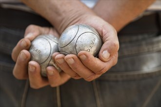 Male hands holding Petanque balls