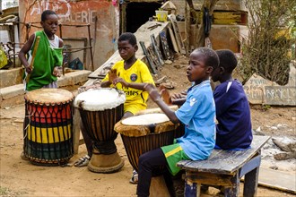 Senegalese children make music with drums
