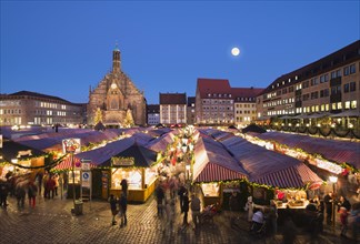 Nuremberg Christmas Market with Church of Our Lady at full moon