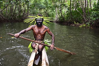 Korafe-Man paddling in a dugout boat