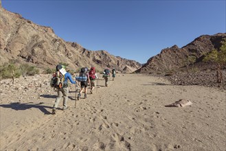 Hikers in dry riverbed