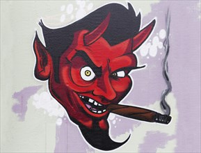 Red devil smoking cigar