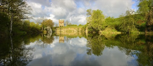 Romanesque church ruins reflected in the lake