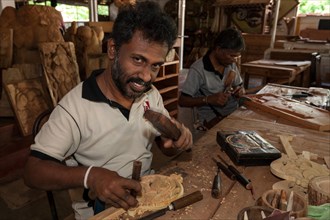Native Sinhalese men carving traditional objects