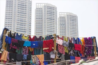 Colorful clothes on clothesline in front of skyscrapers