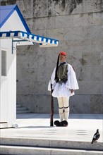 Evzone in front of the Tomb of the Unknown Soldier on Syntagma Square in Athens