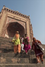 Indian women descending stairs from Buland Darwaza
