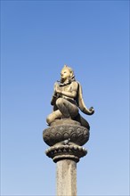 Golden statue of Garuda on a column