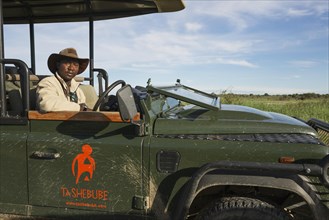 A driver and guide in a safari jeep
