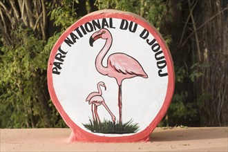Painted sign with flamingos at entrance to Parc National du Djoudj