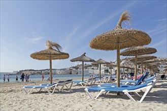 Beach with deck chairs and parasols
