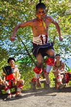 Naga tribal man in traditional outfit performing a warrior dance