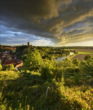 Dramatic atmosphere of clouds over Schonburg village and castle in the Saale Valley