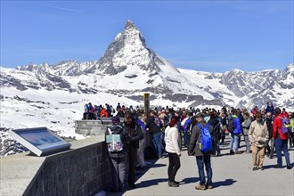 Tourists on the Gornergrat ridge with Matterhorn in the background