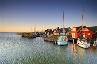 Holiday homes and sailboats in the harbour at Saaler Bodden