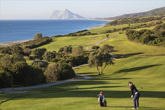 Golfer at La Alcaidesa Golf Resort with Mediterranean Sea and Rock of Gibraltar