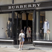 Woman in front of clothing store Burberry