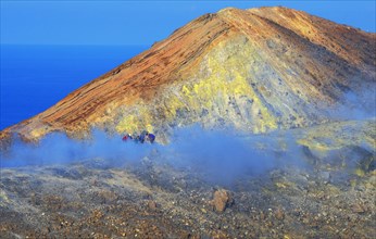 People walking through fumaroles on Gran Crater rim