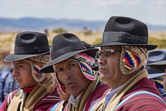 Indigenous men in typical clothing with typical hat