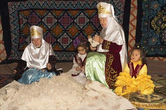 Kazakh women beating and spinning wool