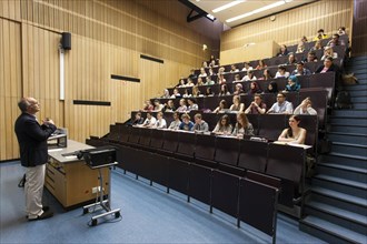 Professor and students during a lecture in the auditorium