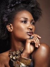 Beautiful young african american woman with big natural hair wearing jewelry