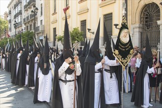Penitents with picture of the Virgin Mary during the procession at Easter