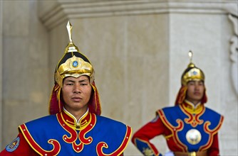 Guardian of the Mongolian armed forces in traditional uniforms in front of the Dschingis-Khan monument at the parliament building
