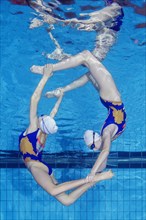 Underwater view of Synchronized Swimming in a swimming pool