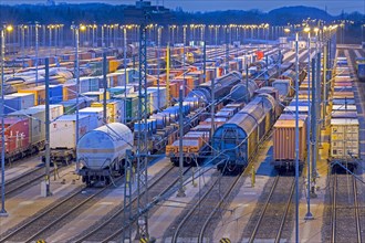 Parked freight cars on tracks at night
