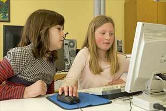 Elementary school girls working in computer room