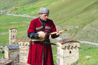 Georgian musician of a folkloric group playing Panduri