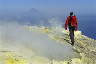 Hiker on the Gran Cratere walks through sulphur fumaroles