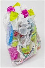 Garbage bag filled with disposable crockery