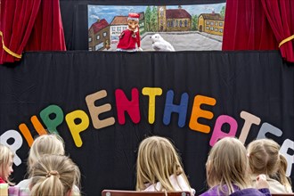 Children watching the puppet theater