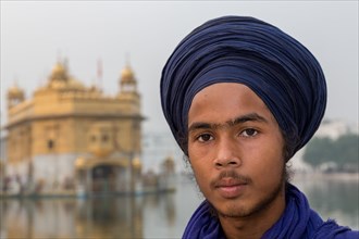 Portrait of young Sikh in front of The Golden Temple